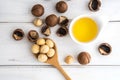 Macadamia Nut Oil and peeled macadamia nut on white table ,Ã¯Â»Â¿ Royalty Free Stock Photo