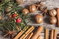 Macadamia nuts and cinnamon on wooden background