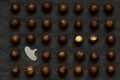 Macadamia nuts on a dark fabric background. Pattern of nuts and shell opening tool, flat lay Royalty Free Stock Photo