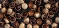Macadamia nuts pattern. Natural raw peeled macadamia seeds and shells Royalty Free Stock Photo