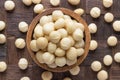 Macadamia nuts peeled in wooden bowl, top view Royalty Free Stock Photo