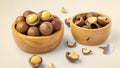 Macadamia nuts with shell in wooden bowls with broken macadamia and tool on beige background Royalty Free Stock Photo