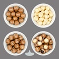 Macadamia nuts, in nutshells and shelled, in white bowls over gray