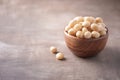 Macadamia nuts in wooden bowl on wood textured background. Copy space. Superfood, vegan, vegetarian food concept. Macro of Royalty Free Stock Photo
