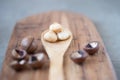 Macadamia peeled in spoon wooden board nutshell