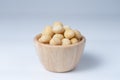 Macadamia in wooden bowl, isolate background Royalty Free Stock Photo