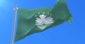 Macanese flag waving at wind with blue sky in slow, loop