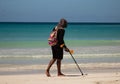 Macao Beach, Bavaro, Dominican Republic, 10 april, 2019 / Man with metal detector searching the beach for coins or precious metals