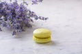 Macaron and bunch lavender on white natural marble table