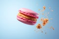 Macaron cake with crumbs on a blue and pink background. Levitating dessert