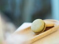 Macaron flavor green tea and coffee in wooden tray plate shape ellipse, Dessert snacks Afternoon on marble table blurred of nature