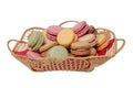 Macaron isolated. Close-up of colourful French macaroons in a basket on red napkin isolated on a white background. Pastries, Royalty Free Stock Photo