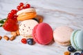 Macaron pink, orange and beige, blue on marble style. A beautiful and beautiful French dessert. Fruits, Strawberries and