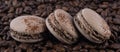 Macaron three coffee flavors on brown arabica grains