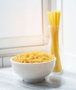 Macaroni in bowl with spaghetti sticks nooddle