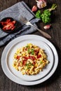 macaroni and cheese with corn, bacon topped with panko breadcrumbs on plates on dark wooden table Royalty Free Stock Photo