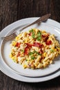 macaroni and cheese with corn, bacon topped with panko breadcrumbs on plates with fork on dark wooden table, vertical view Royalty Free Stock Photo