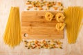 Macaroni of different types on a wooden background