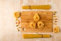 Macaroni of different types on a wooden table and fettuccine on a cutting Board made of bamboo