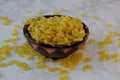 macaroni , dry pasta shaped like narrow tube in wooden bowl