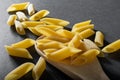 Macaroni from durum wheat on a black background. Royalty Free Stock Photo