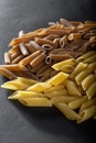 Macaroni from durum wheat on a black background. Royalty Free Stock Photo