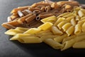 Macaroni from durum wheat on a black background. Royalty Free Stock Photo