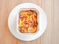 Macaroni with ham and cheese in a baking dish on wooden table. Top view Royalty Free Stock Photo