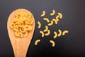 Macaroni in a ladle, black background Royalty Free Stock Photo