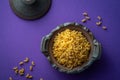 Macaroni pasta uncooked in a rustic small blue dish on a blue mauve background ; flat lay