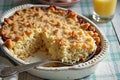 Macaroni pie with breadcrumb topping on a table with orange juice Royalty Free Stock Photo