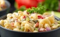 Macaroni Salad with red bell pepper, onion, celery, gherkins and mayonnaise dressing Royalty Free Stock Photo