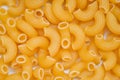 Macaroni top view - close up raw macaroni uncooked delicious pasta or penne noodles Royalty Free Stock Photo