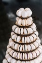 Macarons. Candy bar with a lot of beige macaroons with chocolate in the form of a cone a whole mountain