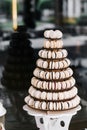 Macarons. Candy bar with a lot of beige macaroons with chocolate in the form of a cone a whole mountain