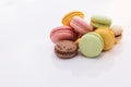 Macarons dessert. Multicolor macarons French macaroon greedy pastry on white background. Food concept