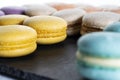 Macarons are laid out on a black slate in beautifully colored rows-2. Royalty Free Stock Photo