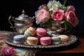 macarons served on an antique silver tray with a teacup