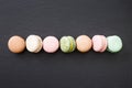Macarons, top view flat lay, sweet macaroon on black slate Royalty Free Stock Photo