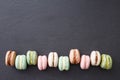 Macarons, top view flat lay, sweet macaroon on black slate Royalty Free Stock Photo