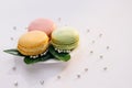 Macarons on white reflective glass, sweet tasty desserts. Multicolor macarons , french macaroon, greedy pastry. French