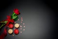 Macaroon on black background and red roses Royalty Free Stock Photo