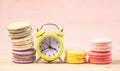 Macaroons and alarm clock on table, vintage stylized photo Royalty Free Stock Photo