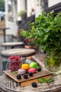 Macaroons with berries on a wooden table