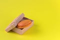 Macaroons box top view. Sweet french macaroons cake on the yellow background Royalty Free Stock Photo