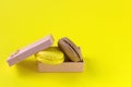 Macaroons box top view. Sweet french macaroons cake on the yellow background Royalty Free Stock Photo
