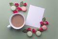 Macaroons, coffee and rose on green background. Top view. Flat lay Royalty Free Stock Photo