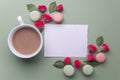 Macaroons, coffee and rose on green background. Top view. Flat lay Royalty Free Stock Photo