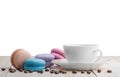 Macaroons with coffee on wooden table