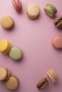 Macaroons colorful cookies. Macarons french sweet dessert, top view, pink background. Copy space Royalty Free Stock Photo